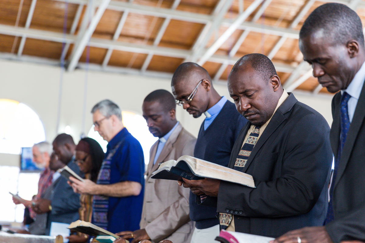 Nairobi - men reading the Bible in a church setting